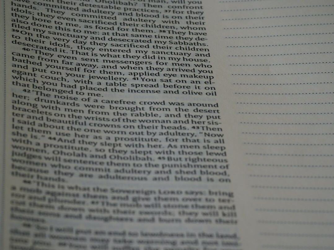 Hand writing in a notebook with a pen